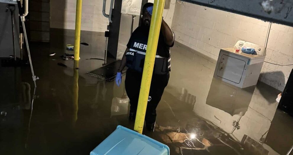 Montréal Cain and other community members after historic Milwaukee floods. (Picture by MERA)